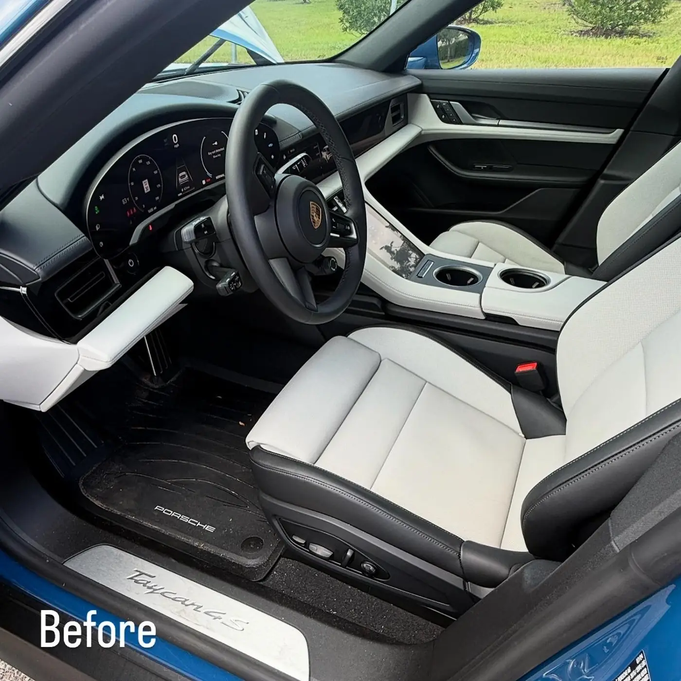 Porsche Taycan interior before detailing, dirty floor mats